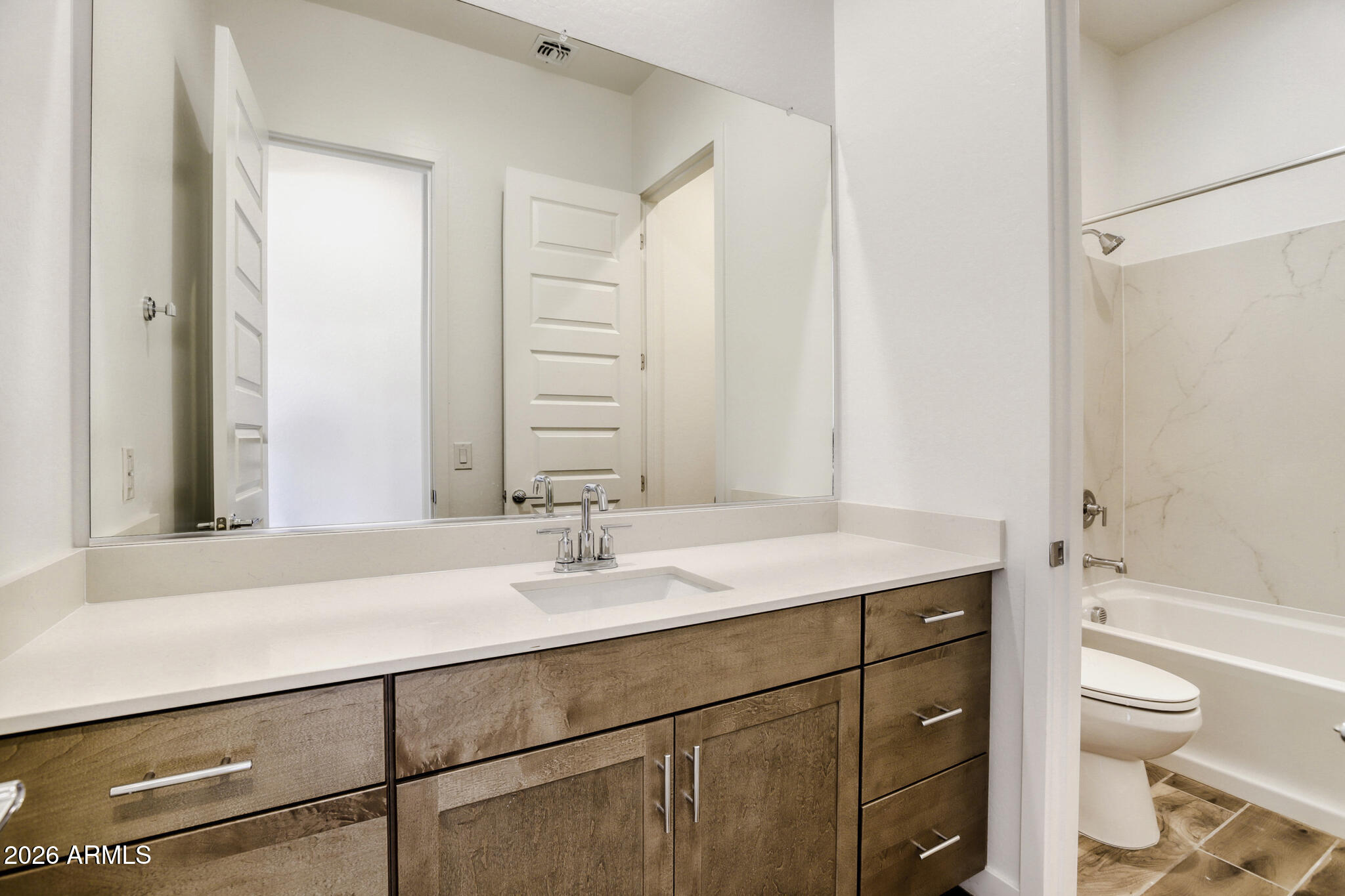 7954 West Rowel Road Peoria, AZ 85383 - Photo 24 of 31 a bathroom with a sink toilet double vanity and bathtub