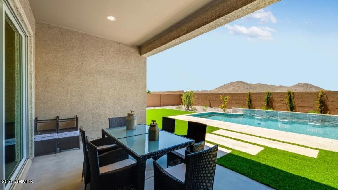 7954 West Rowel Road Peoria, AZ 85383 - Photo 28 of 31 a view of an outdoor kitchen with dining table and chairs