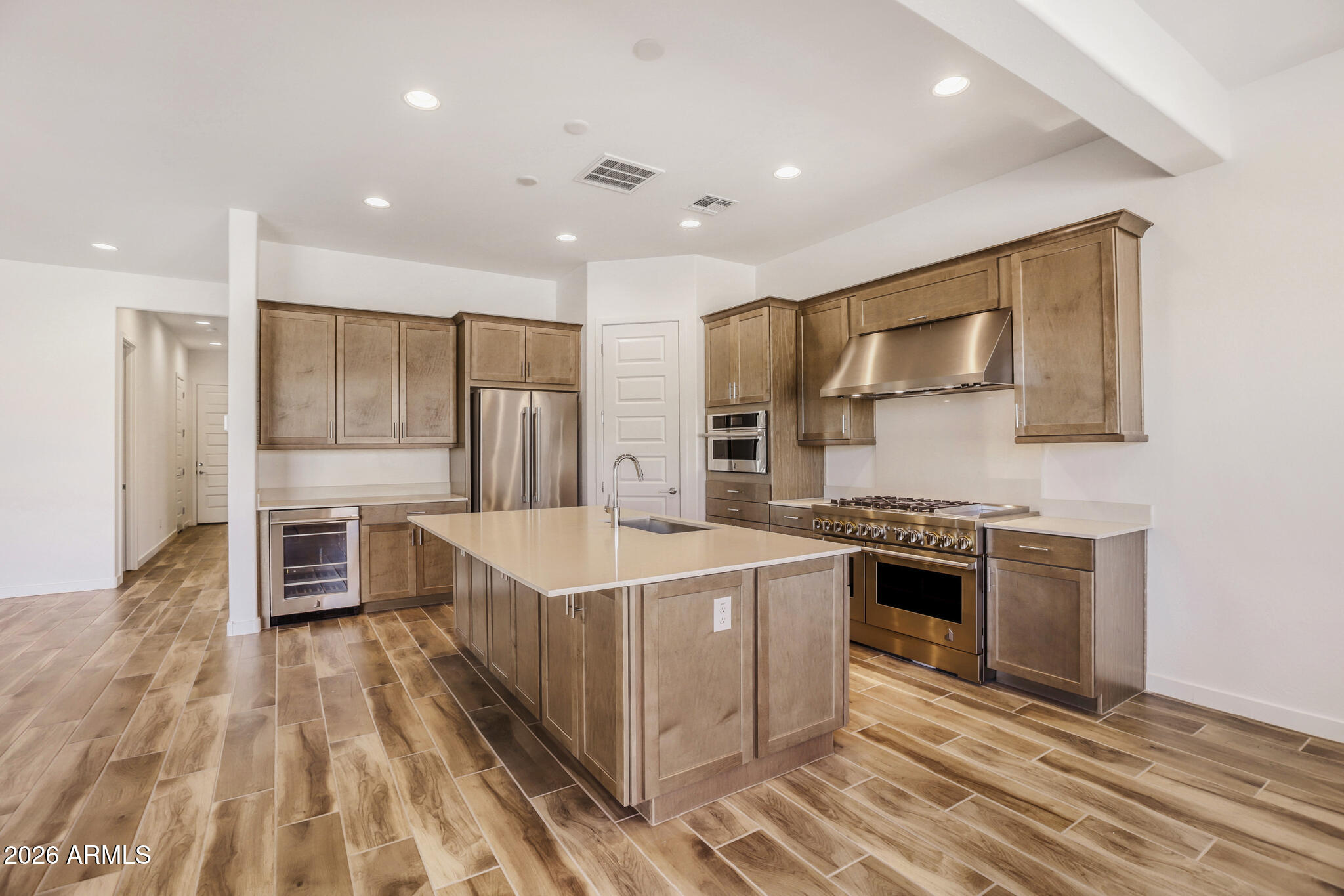 7954 West Rowel Road Peoria, AZ 85383 - Photo 5 of 31 a large kitchen with stainless steel appliances granite countertop a stove and a sink