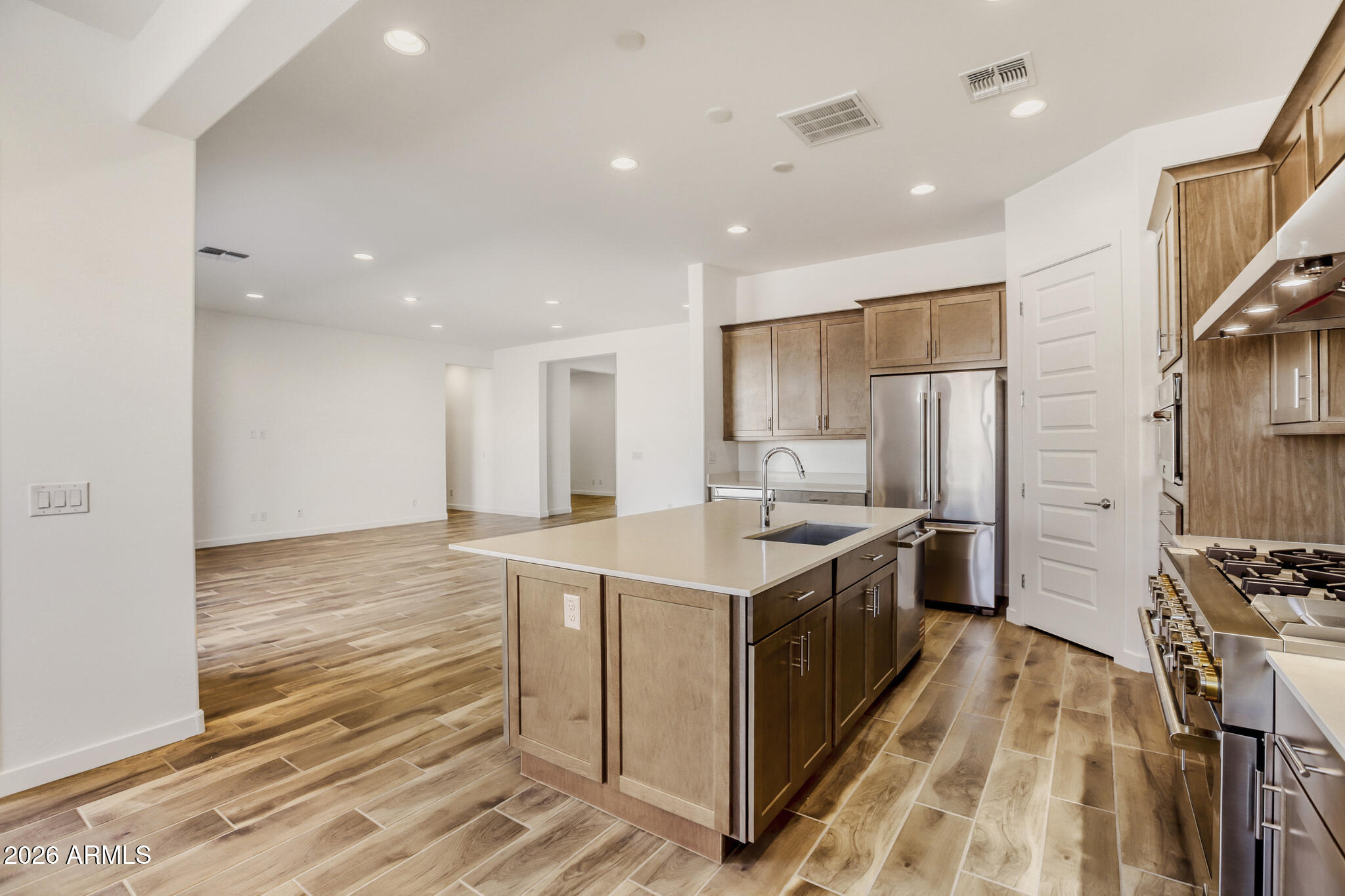 7954 West Rowel Road Peoria, AZ 85383 - Photo 6 of 31 a kitchen with stainless steel appliances a sink stove and refrigerator