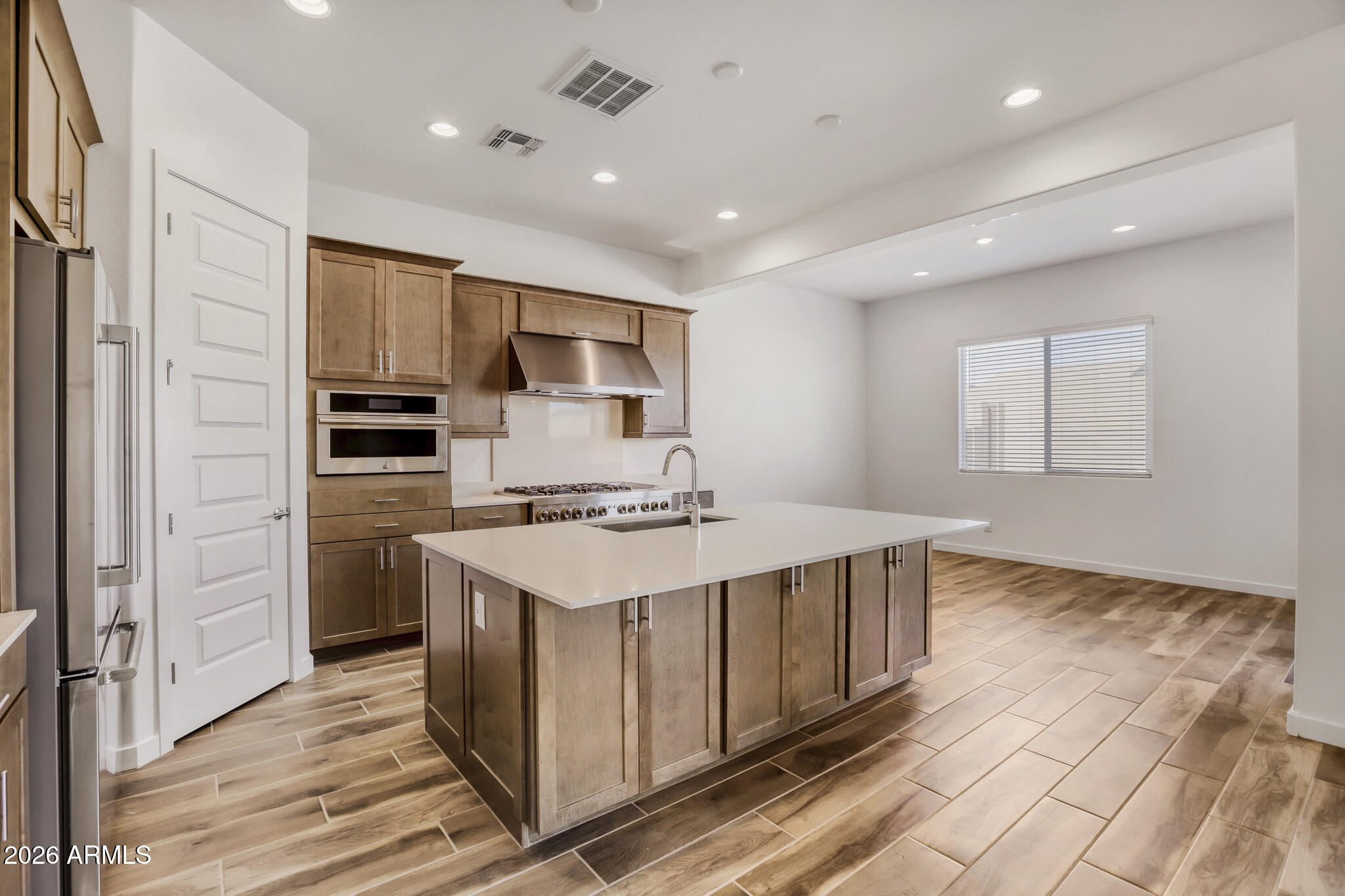 7954 West Rowel Road Peoria, AZ 85383 - Photo 7 of 31 a kitchen with stainless steel appliances a sink stove and refrigerator