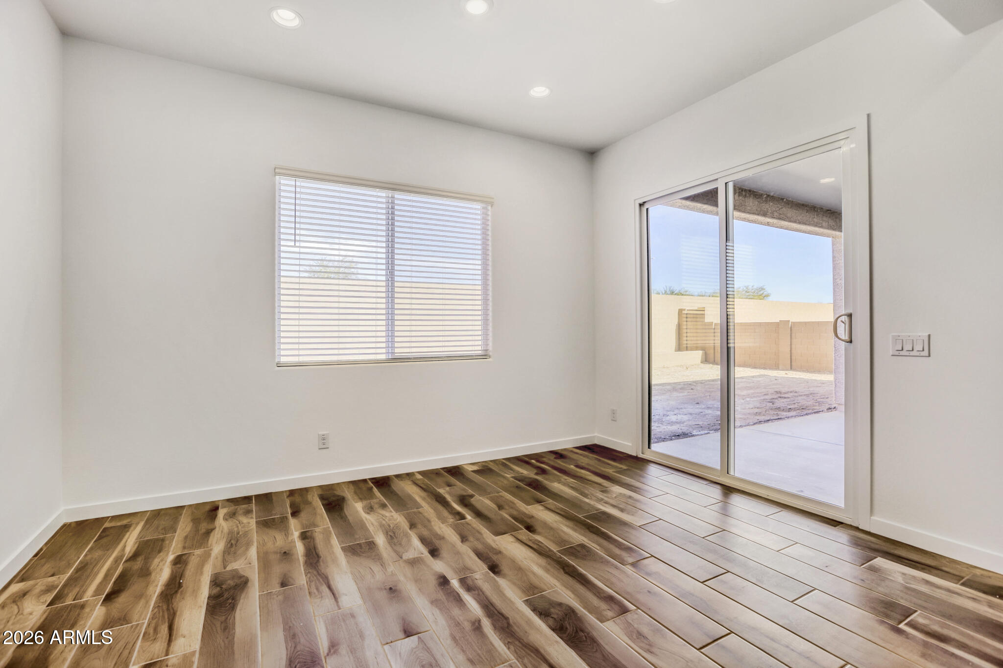 7954 West Rowel Road Peoria, AZ 85383 - Photo 9 of 31 an empty room with wooden floor and windows