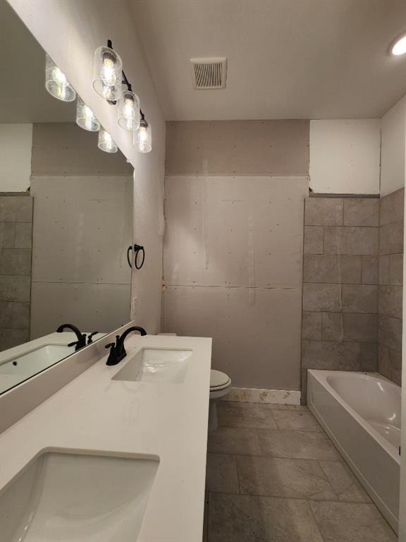 2408 Quartz Street Krum, TX 76249 - Photo 15 of 16 a bathroom with a sink a toilet and shower