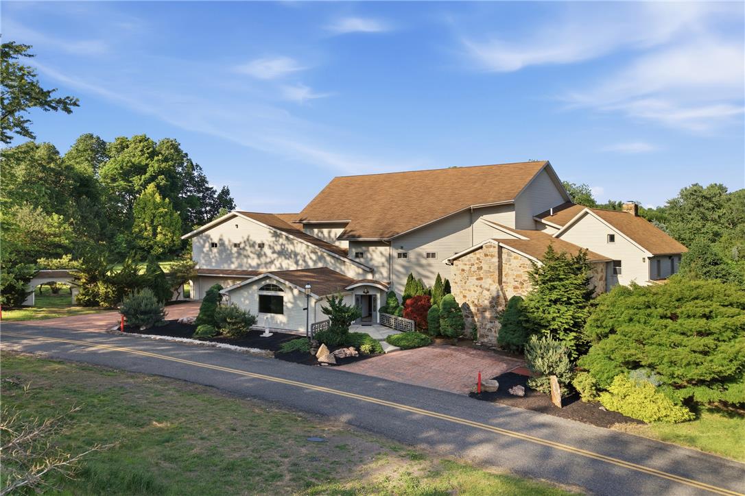 Architectural marvel with a distinctive multi-level design and a welcoming paved driveway.