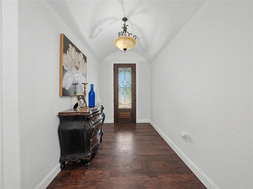 6701 Nauert Road Forest Hill, TX 76140 - Photo 16 of 40 Entryway featuring a wood-finish floor, arched ceiling, and decorative chandelier