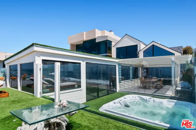 a front view of house with yard and outdoor seating