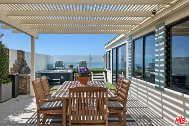 a dinning table and chairs in patio of the house