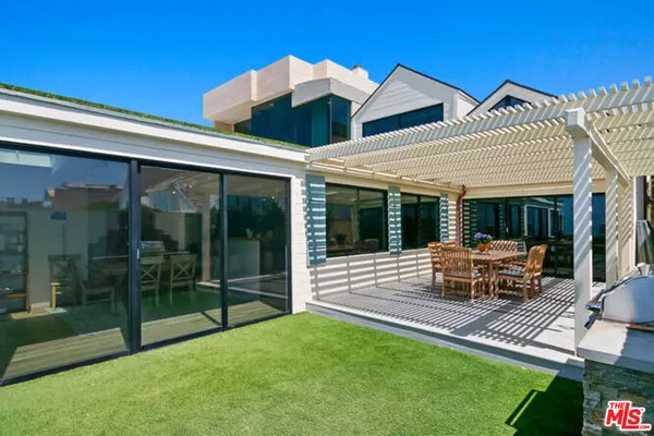 a view of a house with backyard sitting area and garden