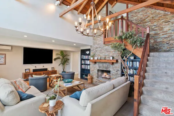 a living room with fireplace furniture and a flat screen tv