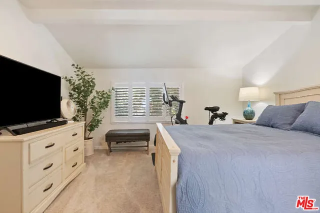 a bedroom with furniture and flat screen tv