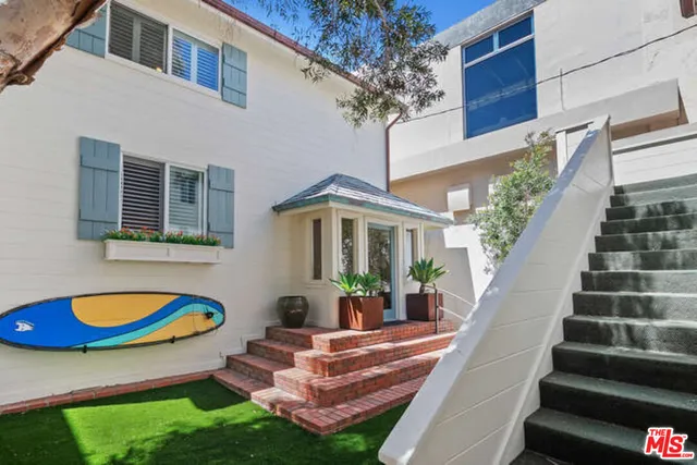 a front view of house with yard and outdoor seating