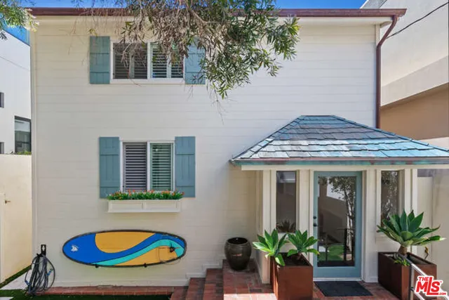 a house view with a potted plant in front of it