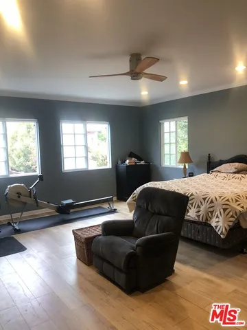 a bedroom with a bed window and couch