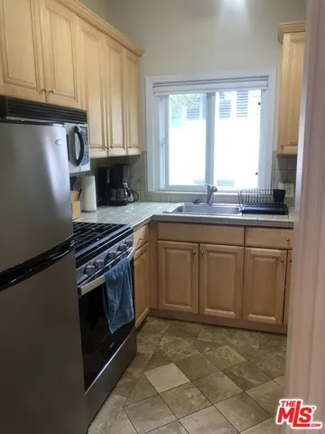 a kitchen with sink cabinets and window