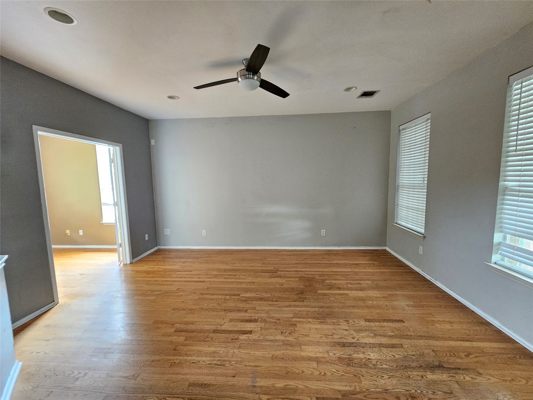 4672 Mather Kyle, TX 78640 - Photo 5 of 28 wooden floor in an empty room with a window