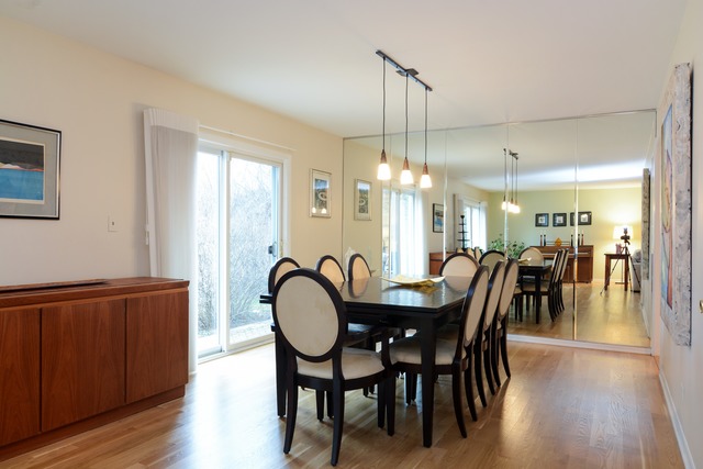 1808 Birch Road Northbrook, IL 60062 - Photo 11 of 24 a dining room with furniture a chandelier and wooden floor