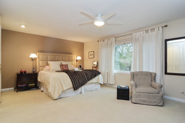 1808 Birch Road Northbrook, IL 60062 - Photo 16 of 24 a spacious bedroom with a bed and a couch