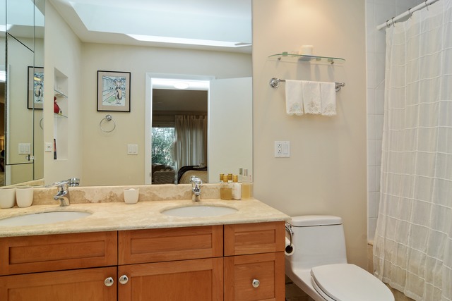 1808 Birch Road Northbrook, IL 60062 - Photo 18 of 24 a bathroom with a granite countertop sink mirror vanity and toilet