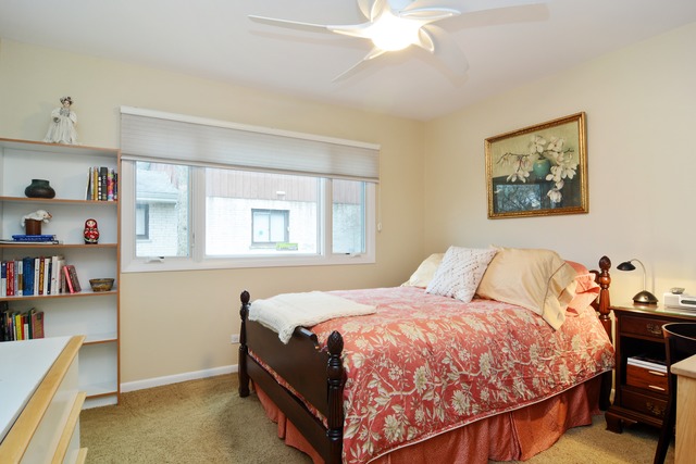 1808 Birch Road Northbrook, IL 60062 - Photo 20 of 24 a bed sitting in a bedroom next to a window