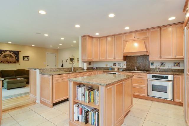 1808 Birch Road Northbrook, IL 60062 - Photo 7 of 24 a kitchen with stainless steel appliances granite countertop a stove a sink and a refrigerator