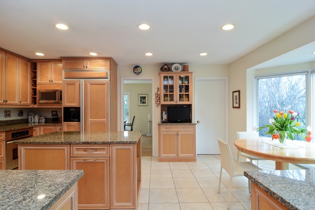 1808 Birch Road Northbrook, IL 60062 - Photo 10 of 24 a kitchen with stainless steel appliances granite countertop a refrigerator a stove and a sink