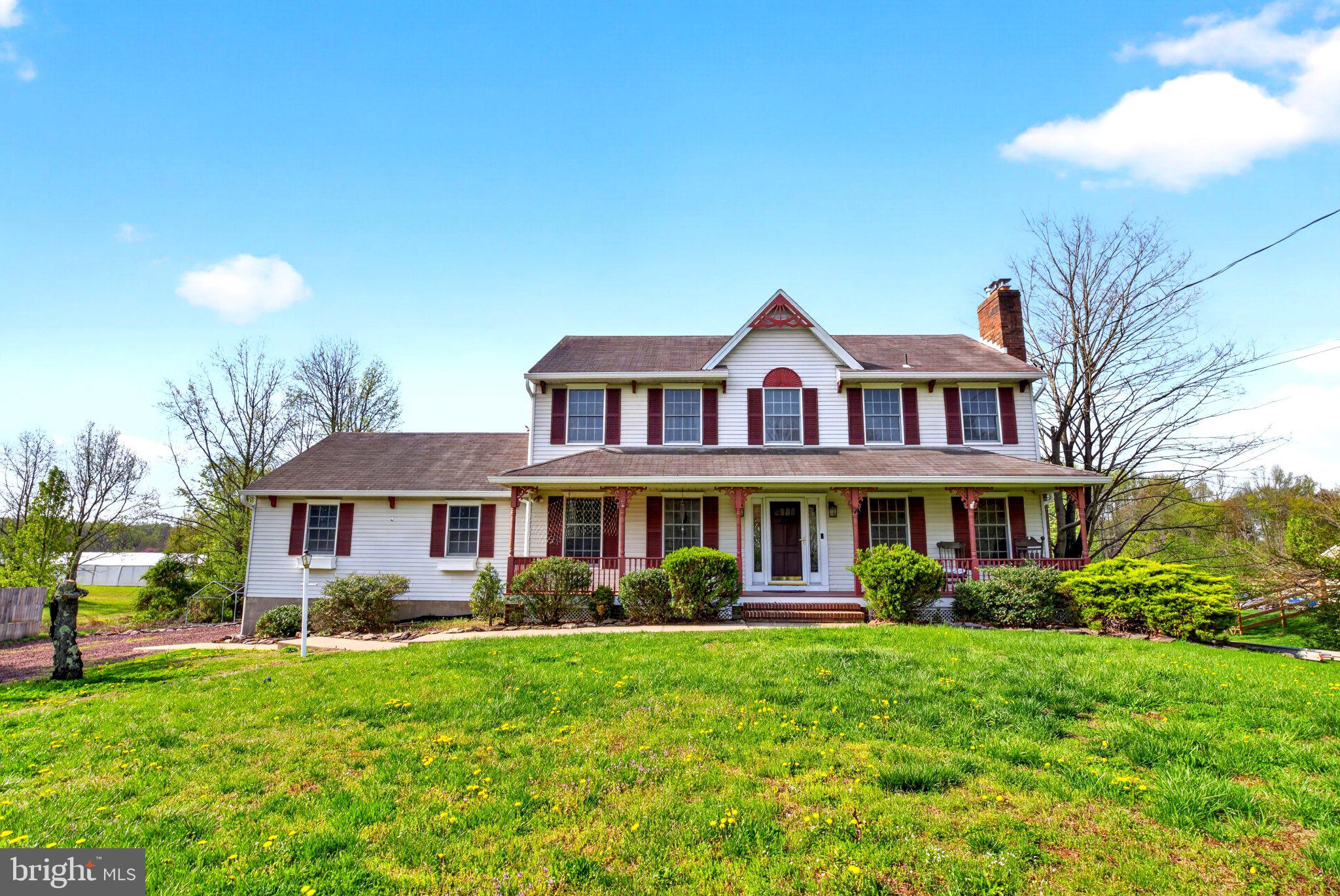 Charming home with lush green surroundings.