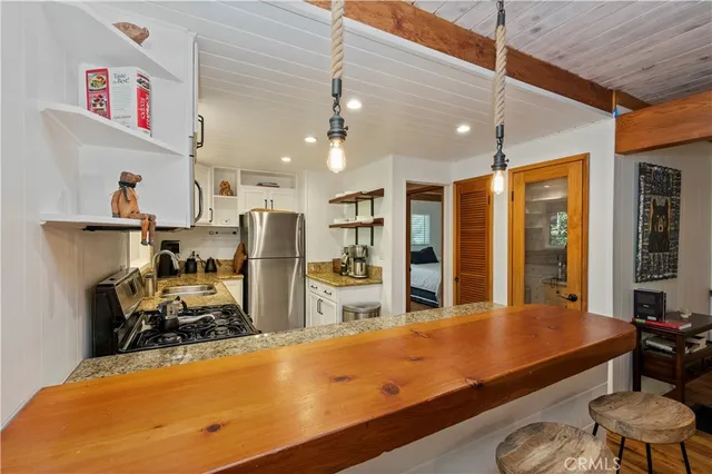 a room with wooden floor pool table and windows
