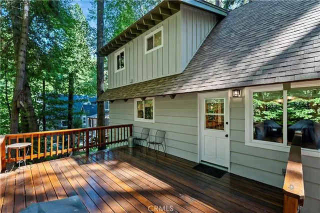 a view of a house with a yard deck and a patio