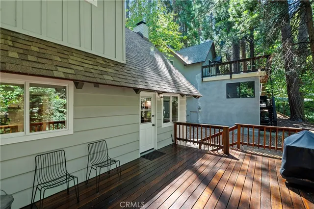 a view of balcony with wooden floor and outdoor seating