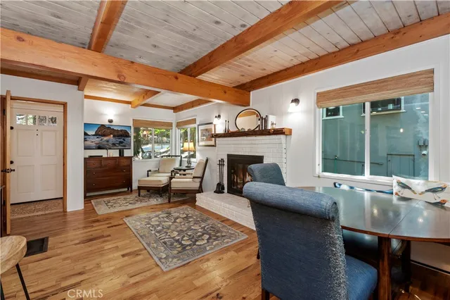 a living room with furniture a fireplace and a table