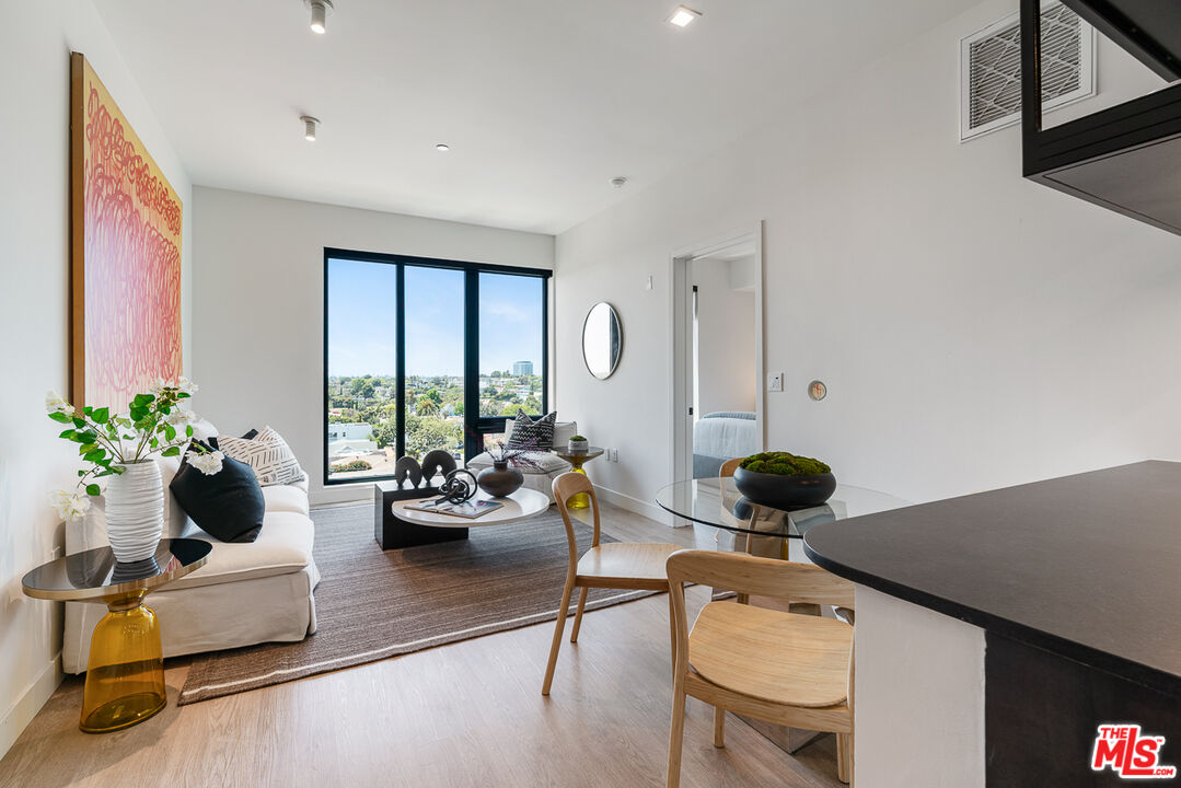 10700 Tabor Street, Unit 524 Los Angeles, CA 90034 - Photo 5 of 29 a living room with furniture and floor to ceiling window