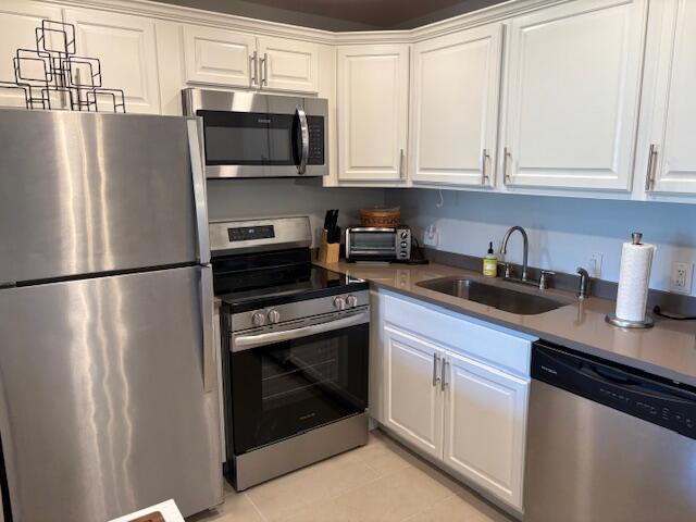 7 Dorset A, Unit 7 Boca Raton, FL 33434 - Photo 1 of 20 a kitchen with stainless steel appliances granite countertop a refrigerator a stove a sink and a microwave