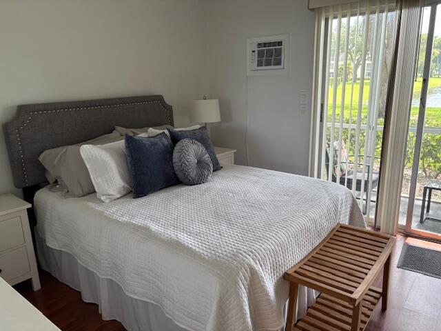 7 Dorset A, Unit 7 Boca Raton, FL 33434 - Photo 12 of 20 a bedroom with a bed and wooden floor