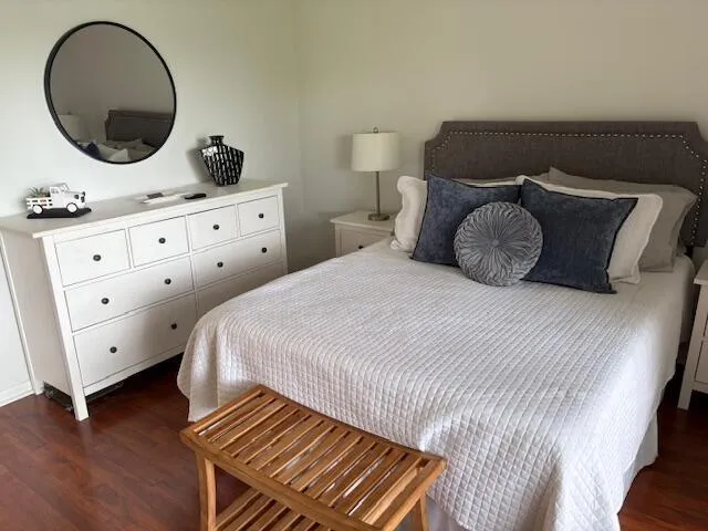 a bedroom with a bed and a dresser