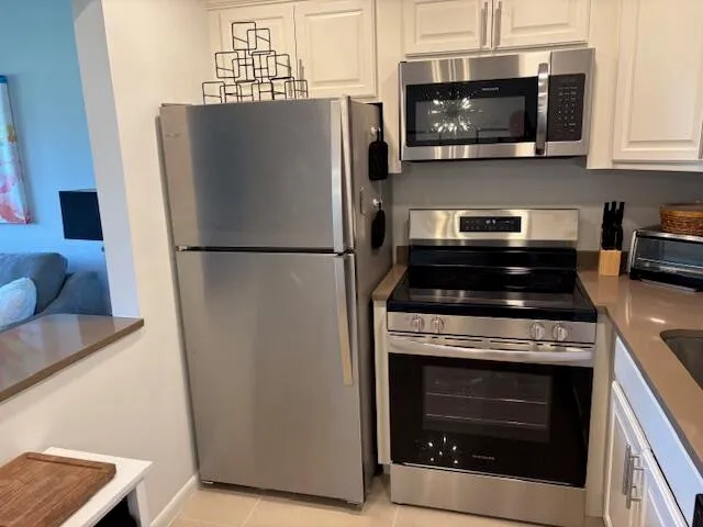 a kitchen with cabinets and stainless steel appliances