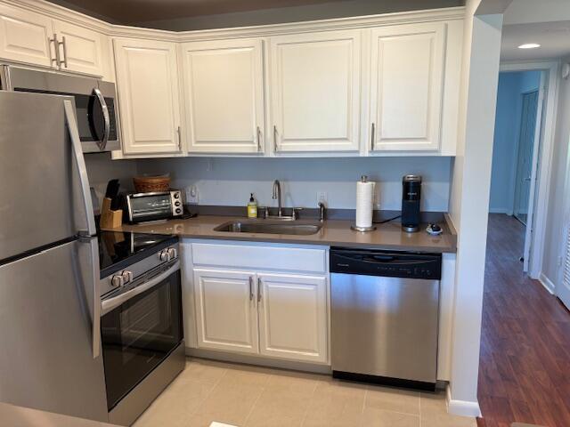 7 Dorset A, Unit 7 Boca Raton, FL 33434 - Photo 3 of 20 a kitchen with granite countertop white cabinets and stainless steel appliances