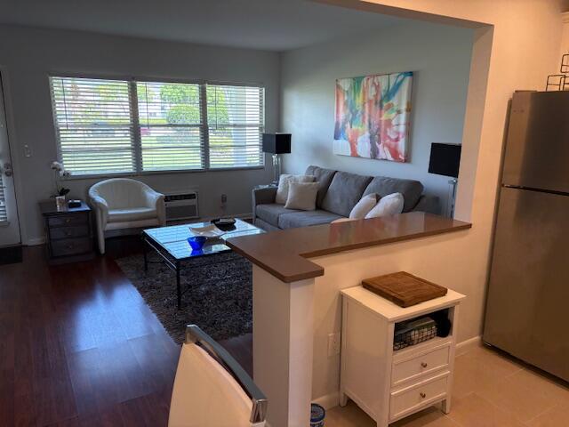 7 Dorset A, Unit 7 Boca Raton, FL 33434 - Photo 9 of 20 a living room with furniture and a flat screen tv