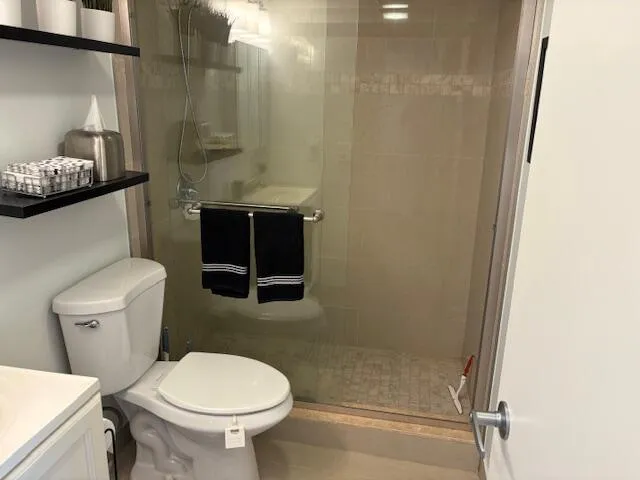 a bathroom with a toilet and a shower
