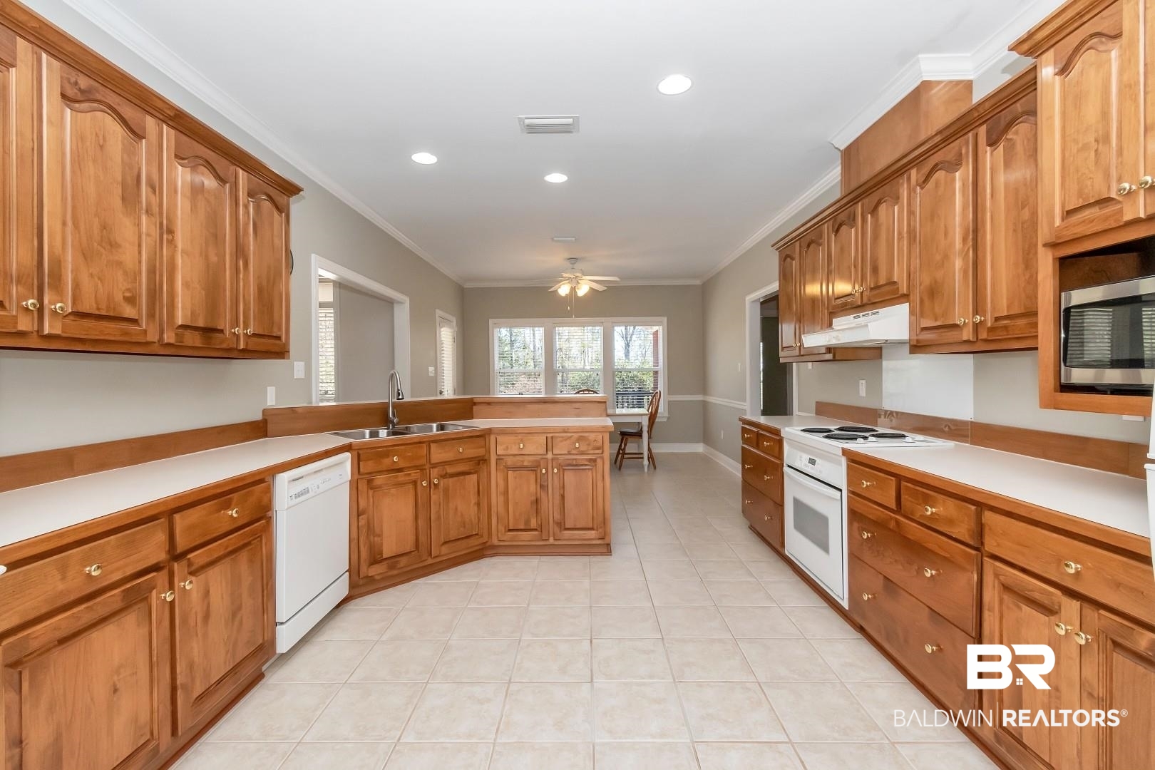 6090 Celeste Road Saraland, AL 36571 - Photo 11 of 38 Kitchen with a sink, crown molding, ceiling fan, and white appliances