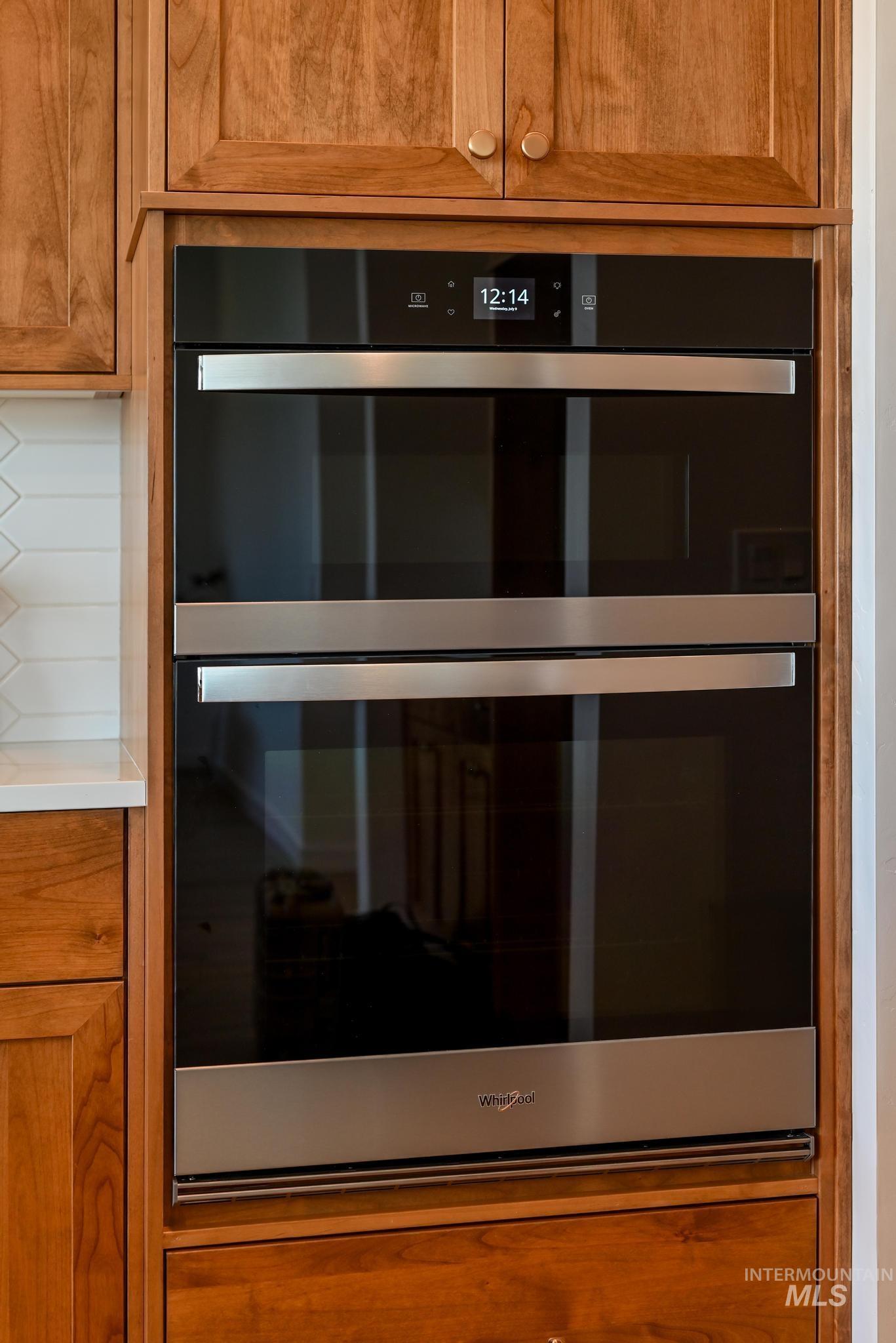 5407 Sparky Avenue Caldwell, ID 83607 - Photo 11 of 41 Kitchen view of brown cabinetry, double oven, and light countertops