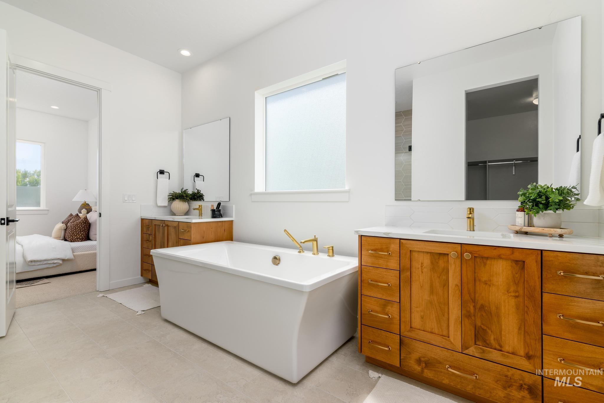 5407 Sparky Avenue Caldwell, ID 83607 - Photo 20 of 41 Bathroom with plenty of natural light, a freestanding bath, vanity, ensuite bath, and recessed lighting