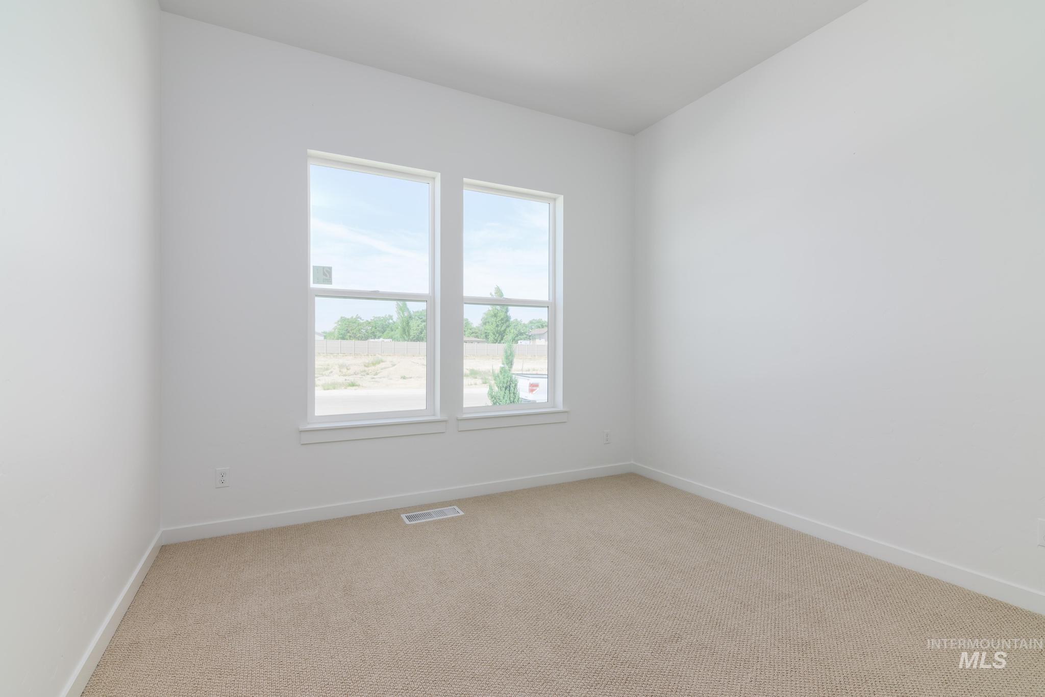 5407 Sparky Avenue Caldwell, ID 83607 - Photo 24 of 41 Unfurnished room with light carpet and baseboards
