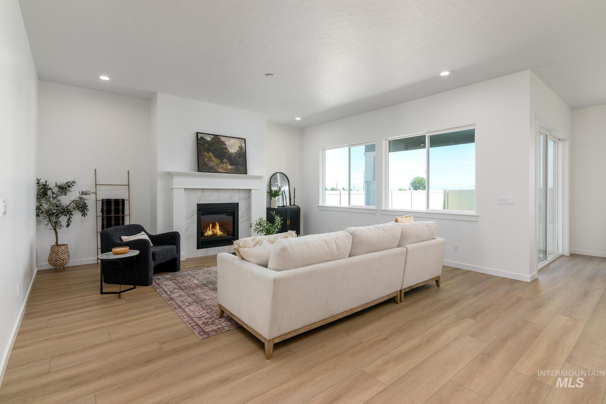 5407 Sparky Avenue Caldwell, ID 83607 - Photo 5 of 41 Living area with a fireplace, light wood finished floors, and recessed lighting