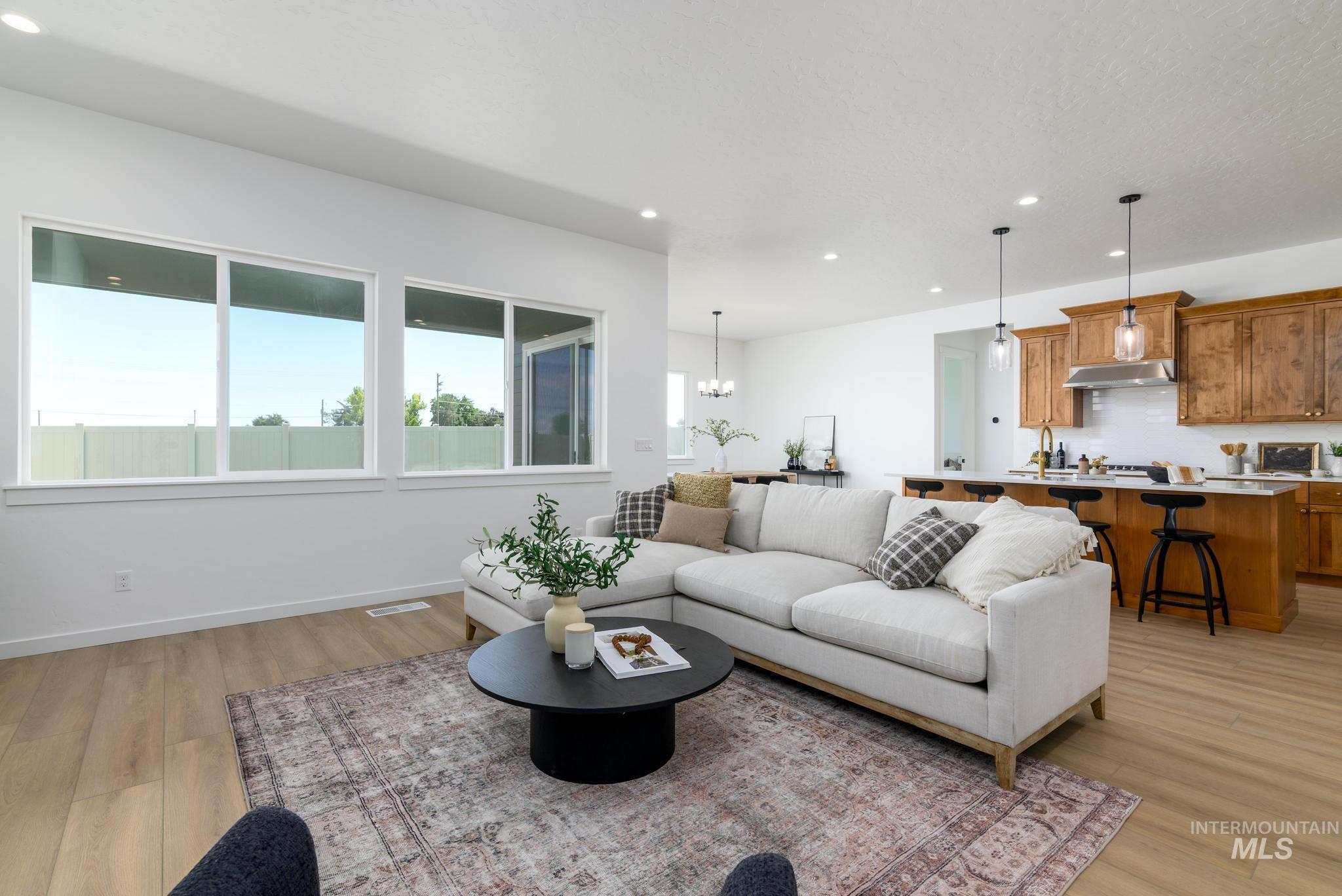 5407 Sparky Avenue Caldwell, ID 83607 - Photo 7 of 41 Living room featuring recessed lighting, a chandelier, and light wood-type flooring