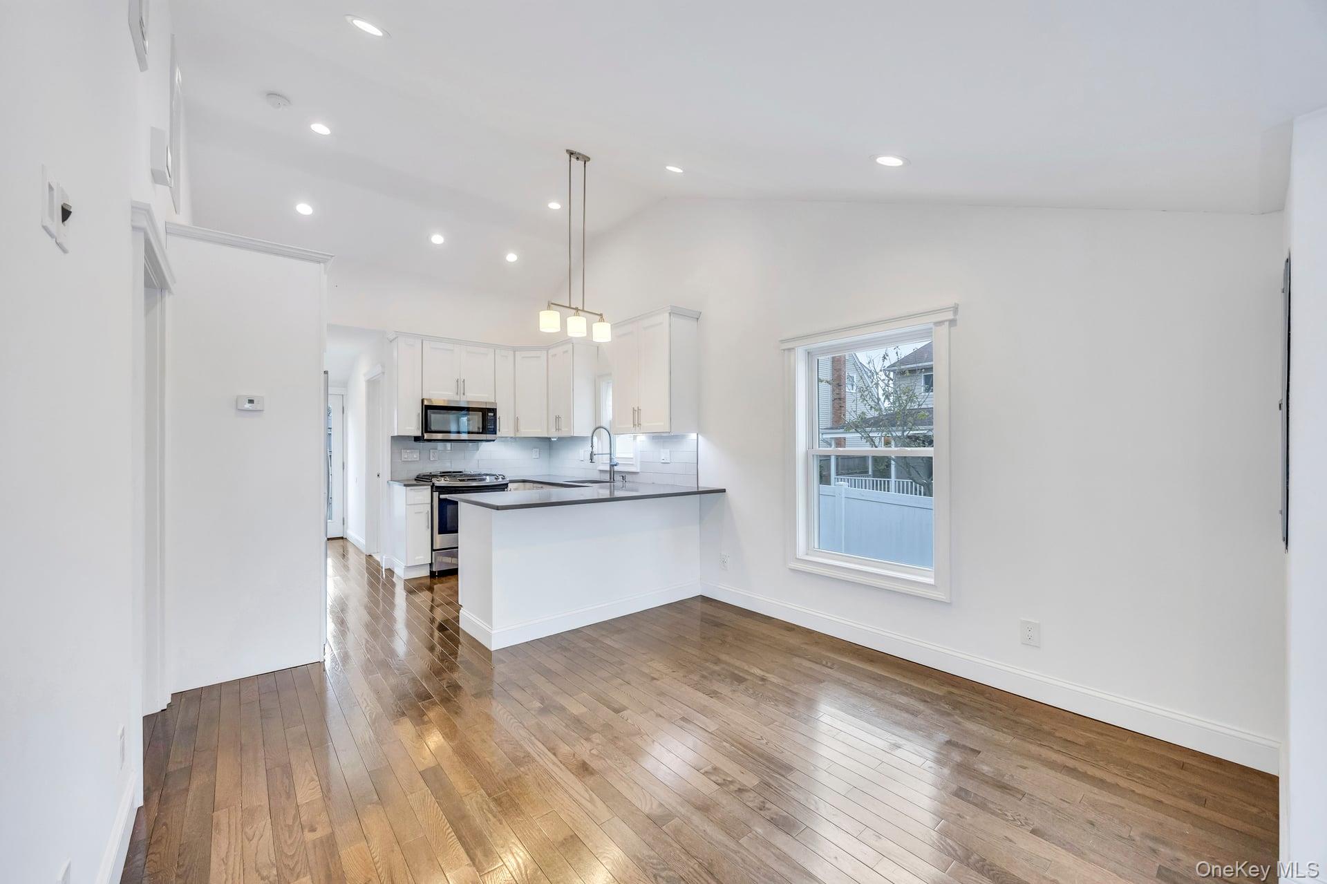 21 Ireland Place Copiague, NY 11726 - Photo 12 of 26 a kitchen with a refrigerator and window