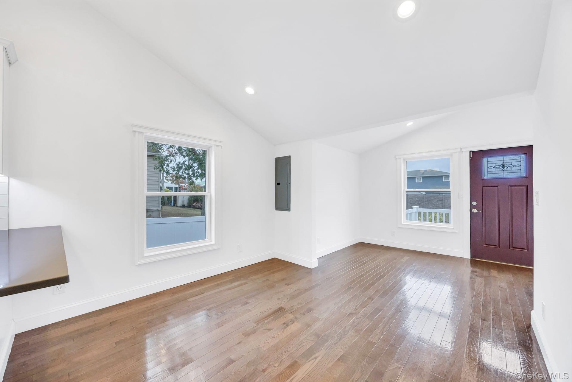 21 Ireland Place Copiague, NY 11726 - Photo 13 of 26 a view of an empty room with wooden floor and a window