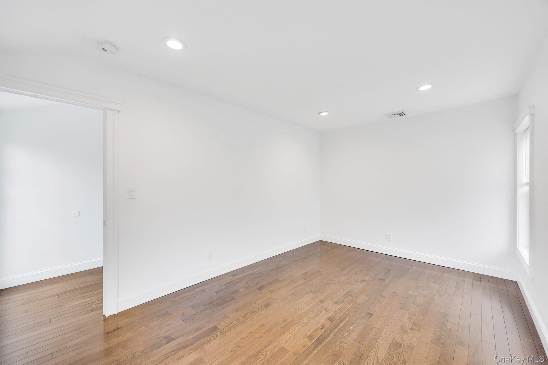 21 Ireland Place Copiague, NY 11726 - Photo 25 of 26 a view of empty room with wooden floor