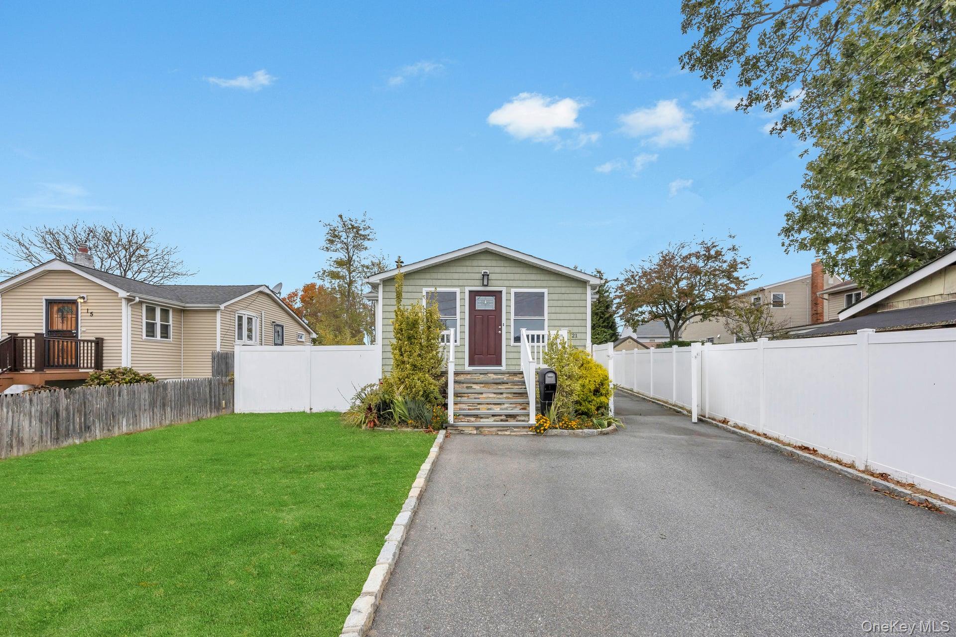 21 Ireland Place Copiague, NY 11726 - Photo 4 of 26 a view of house with outdoor space and entertaining space