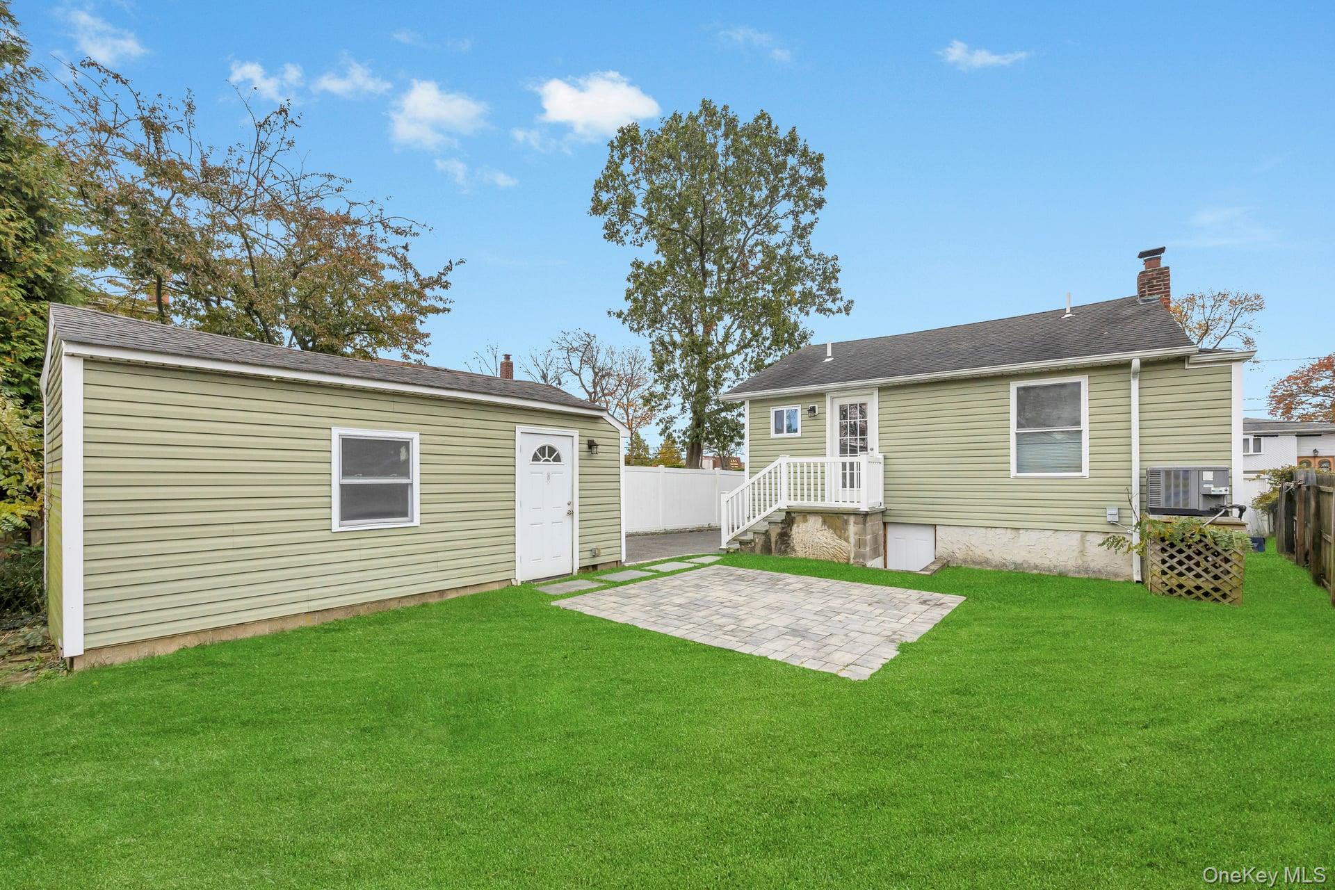 21 Ireland Place Copiague, NY 11726 - Photo 8 of 26 a view of a house with a backyard