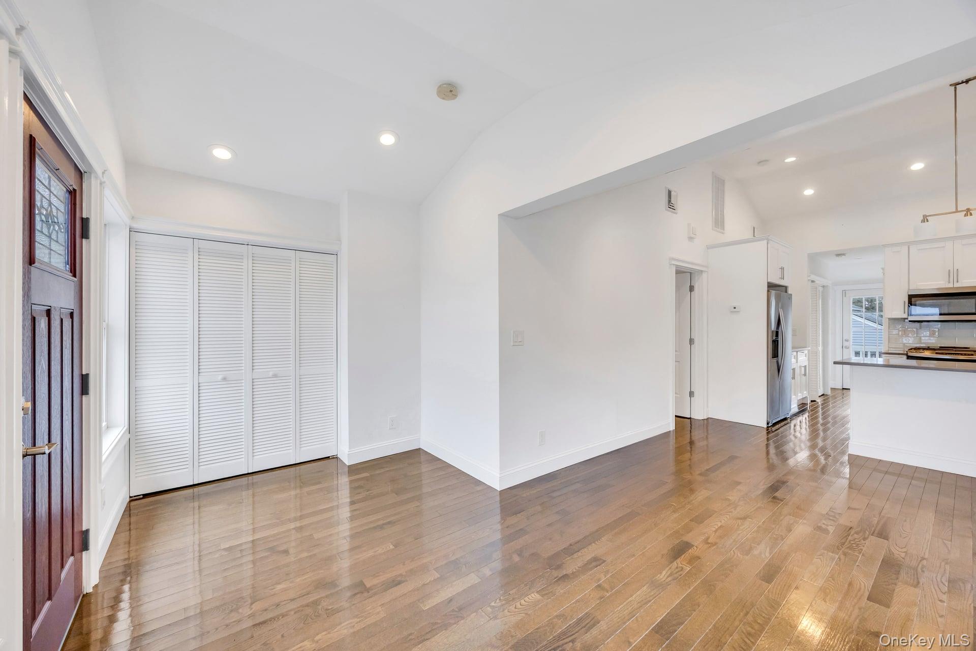 21 Ireland Place Copiague, NY 11726 - Photo 10 of 26 a view of kitchen with wooden floor and electronic appliances